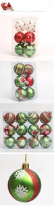 Detailed view of red, green and white Christmas balls with glitter and snowflake patterns
