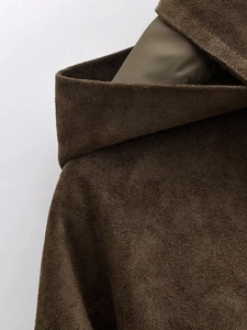 Macro detail of high-quality brown suede texture on a bomber jacket collar