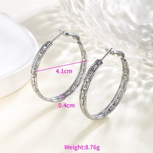 Detail view of 4.1cm silver hoop earrings with textured diamond-cut finish and size specs