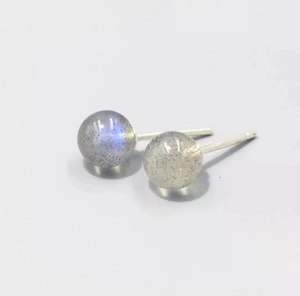 Macro detail of round grey moonstone stud earrings with blue sheen on S999 silver pins