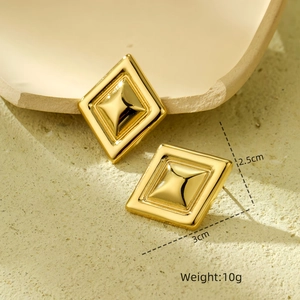 Detail view of gold square geometric earrings with dimensions 2.5cm by 3cm and 10g weight