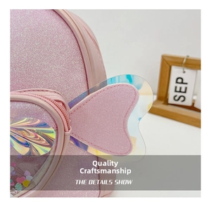 Detail of pink glitter toddler backpack featuring heart window and iridescent wings