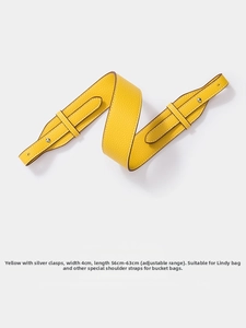 Detail of yellow lychee leather shoulder strap with 4cm width and silver metal buckle