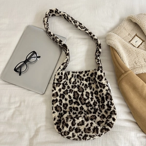 Flat lay of leopard print plush shoulder bag with notebook and glasses for autumn vibes