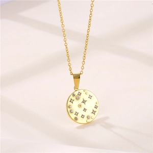 Gold starburst medallion necklace with sparkling crystals on minimalist chain