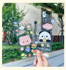 Detail of waterproof PET cartoon stickers with pig and panda motifs on clear material