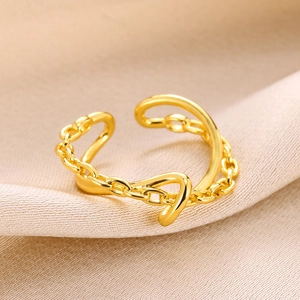 Detail of adjustable gold-plated double-layer ring featuring a smooth arc and chain design