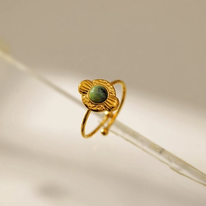Detail of vintage gold ring with turquoise stone and ethnic pattern in macro view