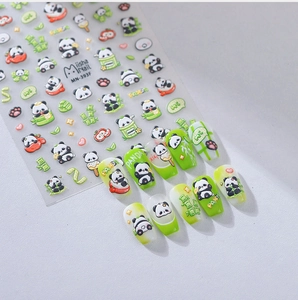 Close-up of MN-393F panda nail art stickers with bamboo and red apple 3D textures