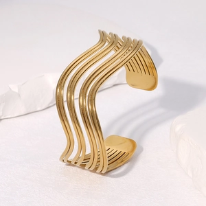 Minimalist multi-line wavy gold open bangle bracelet in polished stainless steel