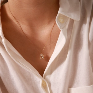 Detail shot of a square gemstone pendant on a 18K gold plated stainless steel necklace