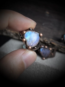 Macro detail of natural labradorite gemstone ring with vintage bronze plated setting