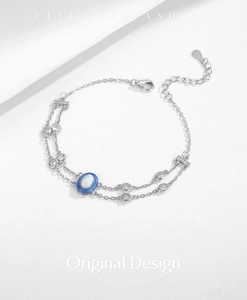 Detail of S925 silver double-layer bracelet with blue oval stone and clear zircons
