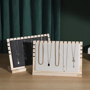 Solid wood necklace display stands with fabric panels on a premium textured background
