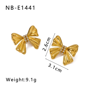 Detail shot of 18K gold plated bow earrings with crystals and sizing specifications