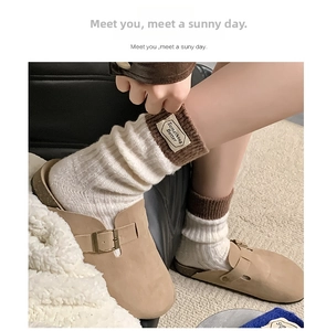 Close-up of wool socks with 'Something Better' label and warm rib cuffs details