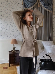 Elegant beige knit cardigan with waist tie, long sleeves, V-neck, and front pockets
