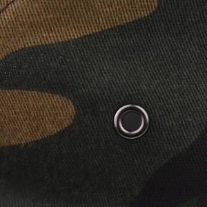 Macro shot of cotton camouflage fabric texture with a black metal ventilation eyelet