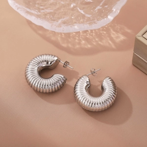 Polished silver titanium steel hoop earrings with textured spiral hollow design