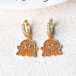 Detailed view of gold ghost hoop earrings with sparkling orange and red zircon stones