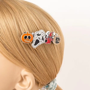 Close-up of Halloween hair clip with pumpkin and ghost motifs on blonde hair