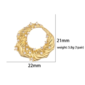 Detailed close-up of golden twisted hoop earrings with cubic zirconia, 21x22mm size