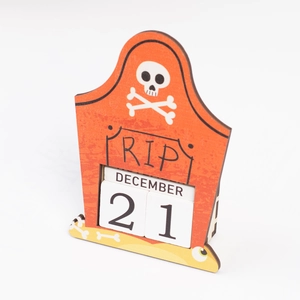 Detail of tombstone-shaped wooden Halloween countdown calendar with RIP text and number blocks