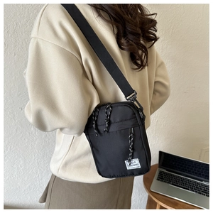 Detail of oxford cloth small crossbody bag with adjustable strap and Hello Weekend label