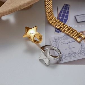 Polished star-shaped stainless steel rings in gold and silver with blessing engraving