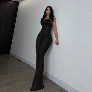 Close-up of slim fit black backless jumpsuit featuring shimmering metallic fabric texture