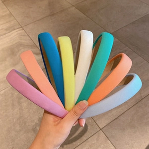 Detail view of 8 colorful thick sponge donut hair bun makers in vibrant assorted shades