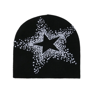 Close-up of black knitted beanie featuring pixelated white star jacquard texture