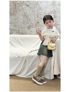 Fashionable girls outfit with solid color mini crossbody bag and stylish denim skirt