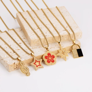 Set of five gold plated fashion necklaces with star, flower, and music note pendants