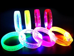 Macro detail of LED glowing bracelets with air bubble texture in multiple neon colors