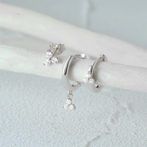 Detailed close-up of a 3-piece silver S925 earring set with sparkling white zircons