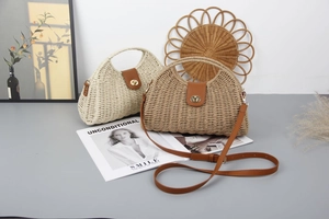 Detail of straw woven bags with leather flap, metal lock, and adjustable shoulder straps