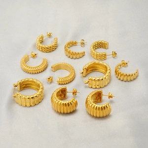 Set of assorted golden stainless steel hoop earrings with textured twisted designs