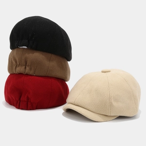 Vintage solid color newsboy caps displayed in black, brown, red and beige colors.