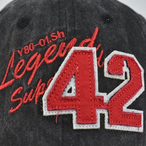 Vintage washed black cotton baseball cap with red number 42 embroidery and retro patches