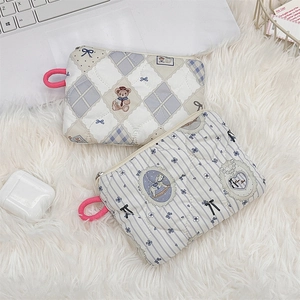Detailed view of quilted cotton makeup bags with cute bear patterns and pink lanyards