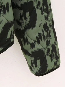Close-up of quilted military green jacket with black leopard print and fine stitching