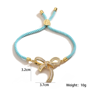 Detailed view of blue woven bracelet showing the 3.2cm bow pendant with white zircons