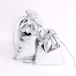 Macro shot of silver metallic drawstring gift bags in two sizes for jewelry storage