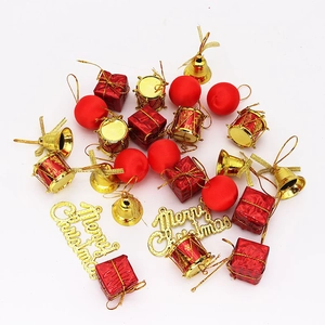 Detailed close-up of festive red and gold Christmas tree ornaments including bells and drums
