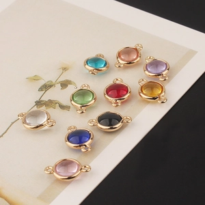 Macro shot of colorful round crystal connectors with gold plated frames for DIY jewelry