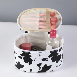 Large capacity cow print cosmetic bag with portable handle and zipper closure in white