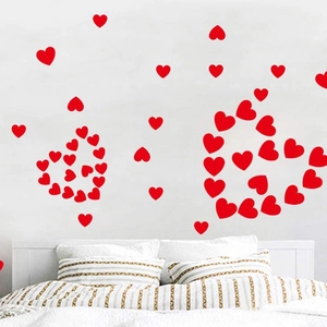 Red heart-shaped wall stickers forming a large heart pattern for bedroom home decor