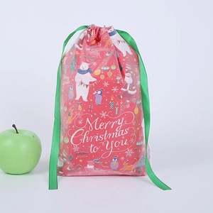 Detail of red Christmas PE drawstring gift bag with Merry Christmas text and green ribbon