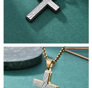 Detailed view of dual-tone cross pendant with textured finish and gold box chain necklace
